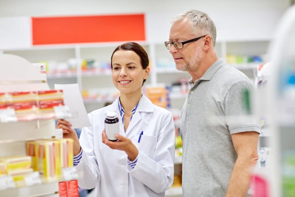 Pharmacist helping customer choose medication
